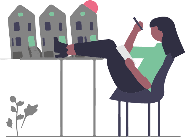 En kvinna som sitter med fötterna på bordet. På bordet är tre minityrer av bostadshus